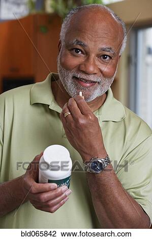 African man taking vitamin View Large Photo Image Stock Image - African man taking vitamin. Fotosearch