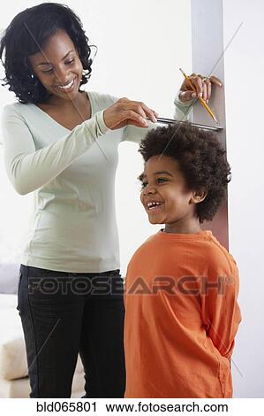 African mother measuring son’s height View Large Photo Image Stock Image - African mother measuring son’s height. Fotosearch