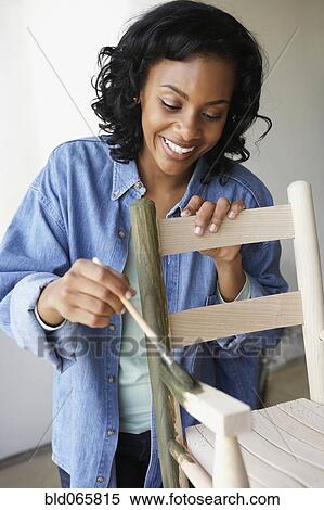 African woman painting rocking chair View Large Photo Image Stock Photography - African woman painting rocking chair. Fotosearch