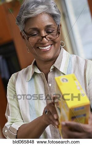 African woman reading food ingredients View Large Photo Image Stock Photo - African woman reading food ingredients. Fotosearch