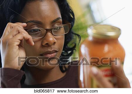 African woman reading sauce ingredients View Large Photo Image Stock Photo - African woman reading sauce ingredients. Fotosearch