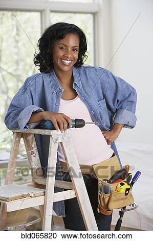 African woman with drill and toolbelt View Large Photo Image Stock Image - African woman with drill and toolbelt. Fotosearch