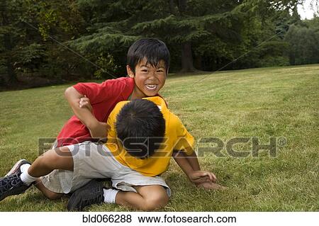Stock Photo - Asian boys playing in park. Fotosearch