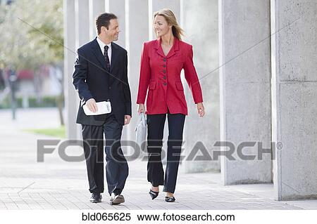 Businesspeople walking together outdoors View Large Photo Image Stock Photography - Businesspeople walking together outdoors. Fotosearch