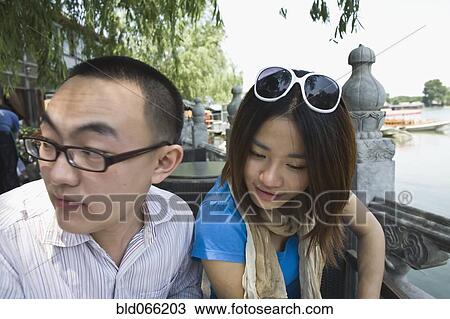 Chinese couple sitting at sidewalk cafe View Large Photo Image Stock Image - Chinese couple sitting at sidewalk cafe. Fotosearch