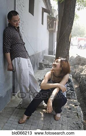 Chinese couple standing on sidewalk View Large Photo Image Stock Image - Chinese couple standing on sidewalk. Fotosearch