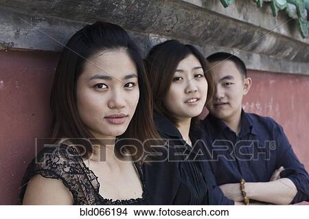 Picture - Chinese friends sitting outdoors. Fotosearch