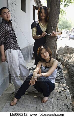 Chinese friends standing on sidewalk View Large Photo Image Stock Image - Chinese friends standing on sidewalk. Fotosearch