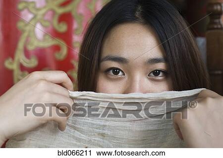 Chinese woman hiding behind scarf View Large Photo Image Stock Image - Chinese woman hiding behind scarf. Fotosearch