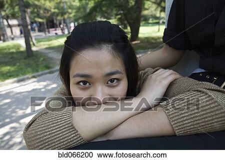 Chinese woman in park with arms crossed View Large Photo Image Stock Image - Chinese woman in park with arms crossed. Fotosearch