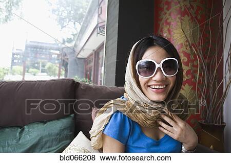 Stock Photo - Chinese woman in scarf and trendy sunglasses. Fotosearch