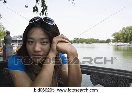 Chinese woman sitting in sidewalk cafe View Large Photo Image Stock Photography - Chinese woman sitting in sidewalk cafe. Fotosearch