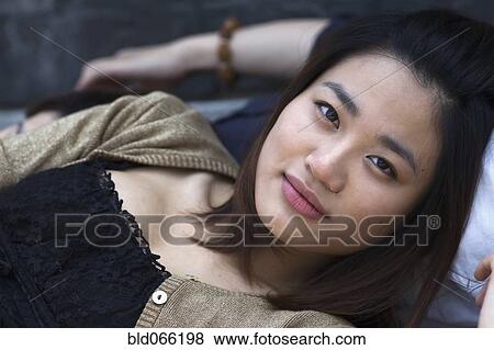 Stock Photo - Close up of Chinese woman laying down. Fotosearch
