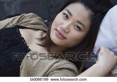 Close up of Chinese woman laying down View Large Photo Image Stock Photo - Close up of Chinese woman laying down. Fotosearch