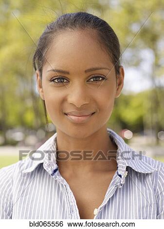 Close up of confident mixed race woman View Large Photo Image Stock Photograph - Close up of confident mixed race woman. Fotosearch