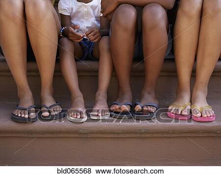 Close up of family’s feet in flip flops View Large Photo Image Stock Photo - Close up of family’s feet in flip flops. Fotosearch