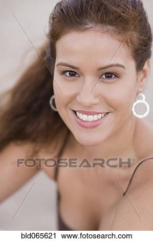 Stock Image - Close up of smiling Hispanic woman. Fotosearch