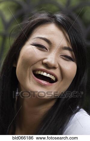 Confident Japanese woman laughing View Large Photo Image Stock Photograph - Confident Japanese woman laughing. Fotosearch