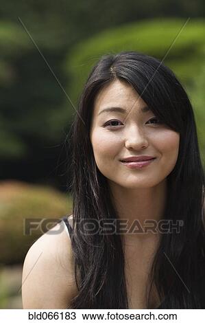 Stock Image - Confident Japanese woman smiling. Fotosearch