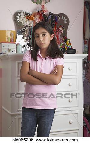 Hispanic girl with arms crossed View Large Photo Image Stock Photograph - Hispanic girl with arms crossed. Fotosearch