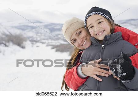 Hispanic mother hugging son in snow field View Large Photo Image Stock Image - Hispanic mother hugging son in snow field. Fotosearch