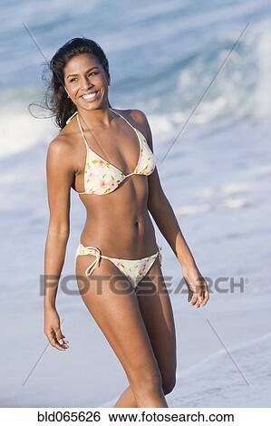 Hispanic woman in bikini at beach View Large Photo Image Stock Photograph - Hispanic woman in bikini at beach. Fotosearch
