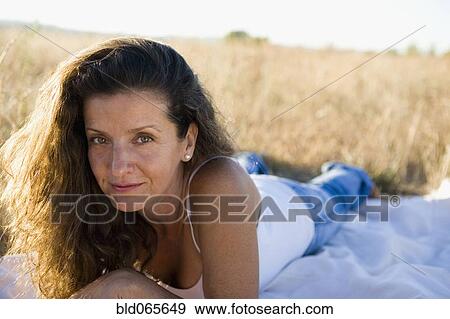 Hispanic woman laying in remote field View Large Photo Image Stock Photo - Hispanic woman laying in remote field. Fotosearch