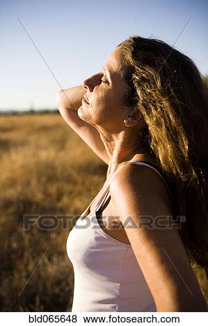 Hispanic woman standing in remote field View Large Photo Image Stock Photo - Hispanic woman standing in remote field. Fotosearch