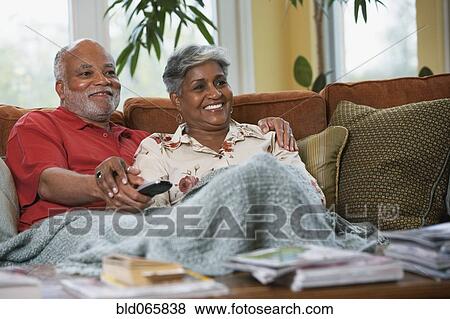 Senior African couple watching television View Large Photo Image Stock Photo - Senior African couple watching television. Fotosearch