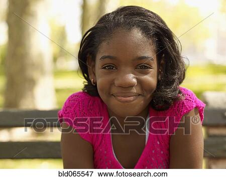Smiling African girl in park View Large Photo Image Stock Photo - Smiling African girl in park. Fotosearch