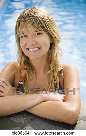 Smiling Hispanic woman standing in swimming pool View Large Photo Image Stock Image - Smiling Hispanic woman standing in swimming pool. Fotosearch