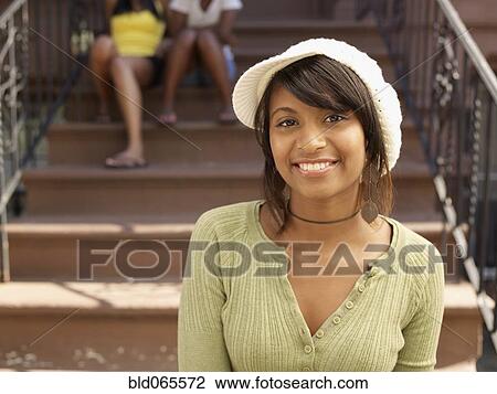 Smiling Hispanic woman with family in background View Large Photo Image Stock Image - Smiling Hispanic woman with family in background. Fotosearch