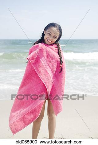 Wet Hispanic girl wrapped in towel on beach View Large Photo Image Stock Image - Wet Hispanic girl wrapped in towel on beach. Fotosearch