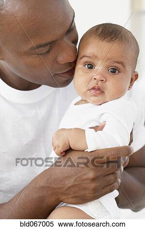 African father hugging baby daughter View Large Photo Image Stock Photography - African father hugging baby daughter. Fotosearch