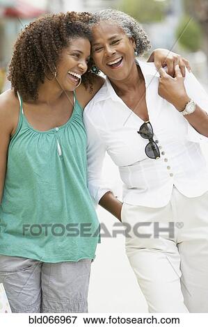 Stock Photo - African mother and daughter walking. Fotosearch