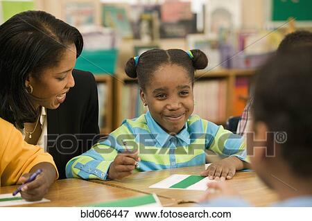 African school teacher helping students View Large Photo Image Stock Photo - African school teacher helping students. Fotosearch