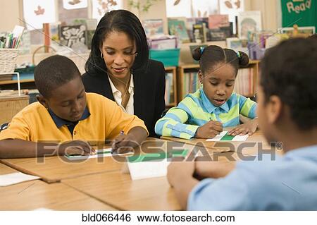 African school teacher helping students View Large Photo Image Stock Photograph - African school teacher helping students. Fotosearch