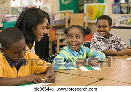 African school teacher helping students View Large Photo Image Stock Photography - African school teacher helping students. Fotosearch