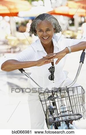 African woman riding bicycle View Large Photo Image Stock Image - African woman riding bicycle. Fotosearch