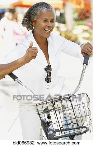 African woman riding bicycle View Large Photo Image Stock Image - African woman riding bicycle. Fotosearch