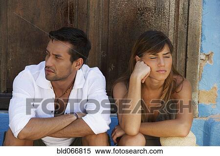 Stock Photography - Angry couple sitting outdoors. Fotosearch