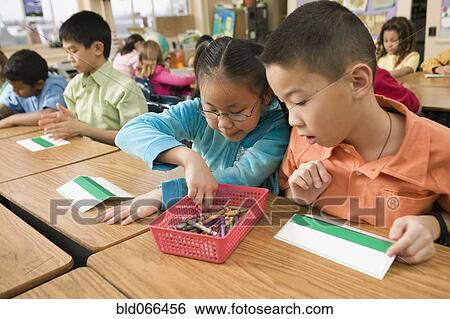 Asian school children making name cards View Large Photo Image Stock Photograph - Asian school children making name cards. Fotosearch