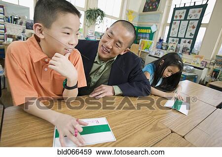 Asian school teacher helping students View Large Photo Image Stock Photo - Asian school teacher helping students. Fotosearch