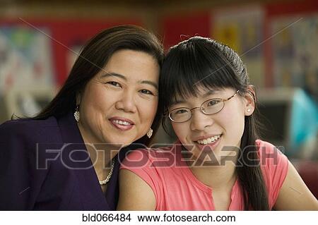 Picture - Asian teacher and student smiling. Fotosearch