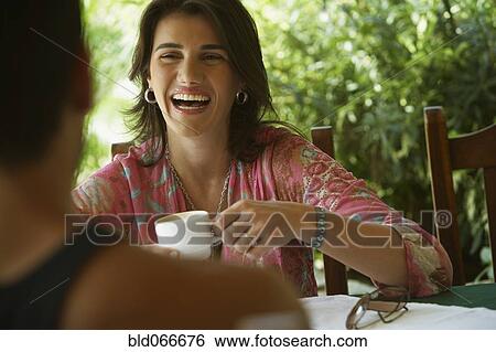 Stock Photograph - Couple drinking coffee in cafe. Fotosearch