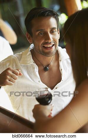 Picture - Couple drinking red wine in cafe. Fotosearch