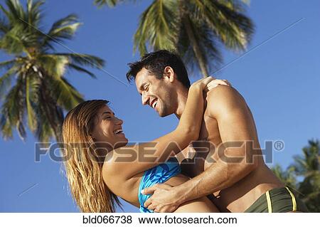 Stock Photo - Couple hugging at beach. Fotosearch