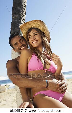Stock Photo - Couple hugging at beach. Fotosearch