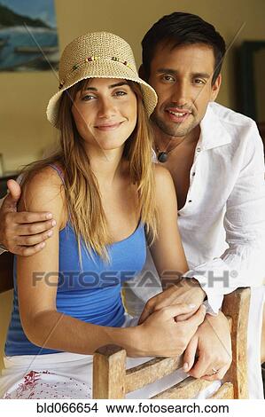 Picture - Couple hugging in bar. Fotosearch