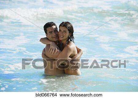Couple hugging in ocean View Large Photo Image Picture - Couple hugging in ocean. Fotosearch